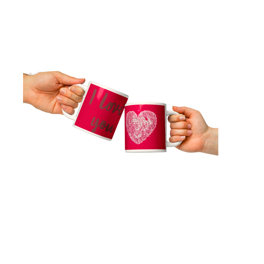 Image of two mugs cheering. Mugs in colour red with I Love you and heart shape 